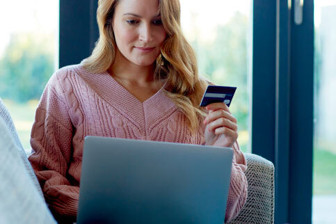 Woman holding capital one card